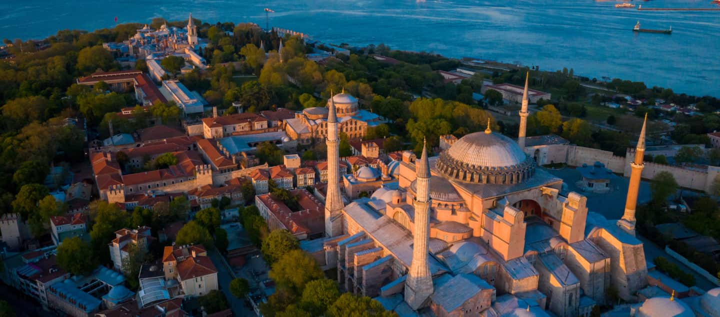 Hagia Sophia's scenic view from a distance, showcasing its majestic domes and minarets, capturing the architectural grandeur of this historic landmark in Istanbul.