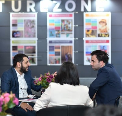 Group of individuals engaged in discussion at a conference table in CBME Türkiye.