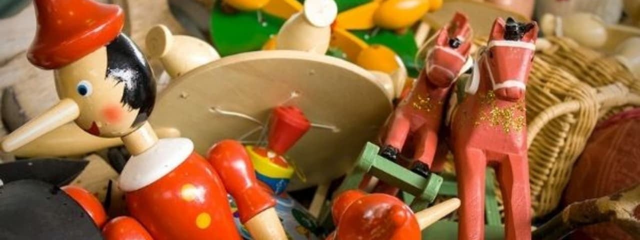 A pile of wooden toys, featuring various shapes and designs, stacked together.