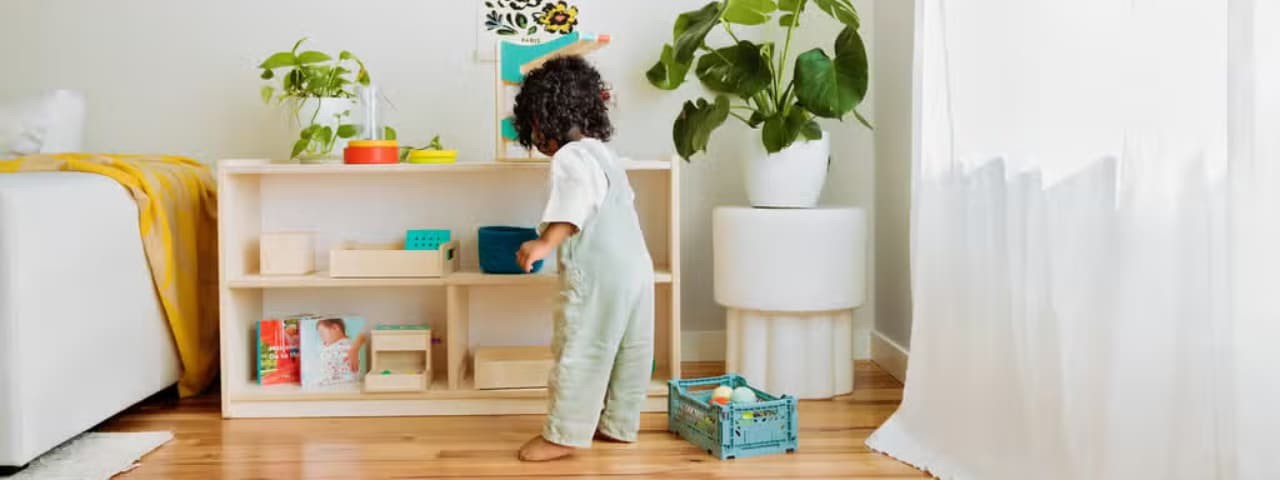 A young child playing with toys in their bedroom.