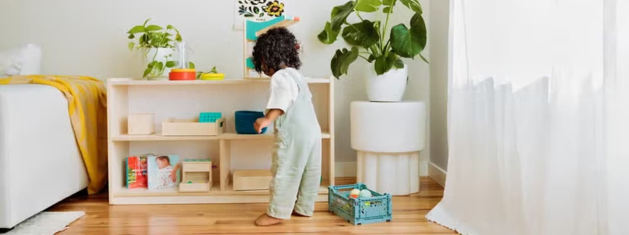A young child playing with toys in their bedroom.